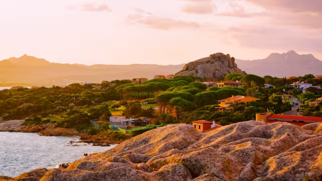 Landscape and scenery of Baja Sardinia luxury resort in Costa Smeralda at sunset evening, Sardegna island in Italy in summer. Olbia province. Villas And Mediterranean sea. Mixed media.