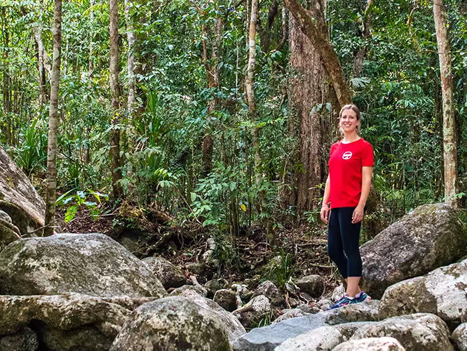 Intrepid leader standing amidst the stones of the Daintree Rainforest