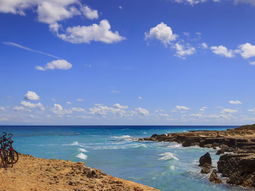 The most beautiful coast of Apulia: Torre Sant' Andrea, Otranto , ITALY (Lecce).Typical coastline of Salento: a pair of bikes for excursions. Seascape with cliffs, rocky arch and sea stacks.