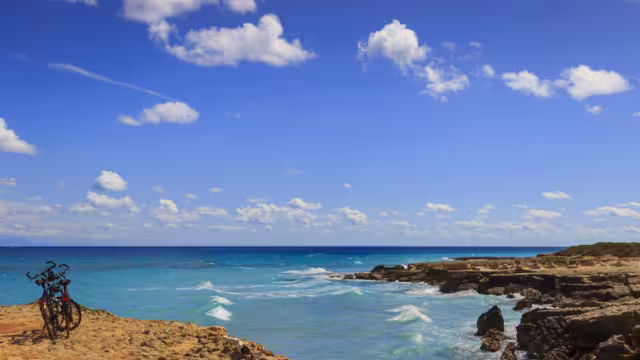 The most beautiful coast of Apulia: Torre Sant' Andrea, Otranto , ITALY (Lecce).Typical coastline of Salento: a pair of bikes for excursions. Seascape with cliffs, rocky arch and sea stacks.