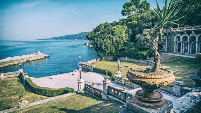 View from Miramare Castle near Trieste, northeastern Italy. Travel destination. Analog photo filter with scratches.