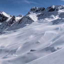 Panorama of the climber on the snow capped mountain range. Ducan Glacier in Switzerland. Freeride in the mountains