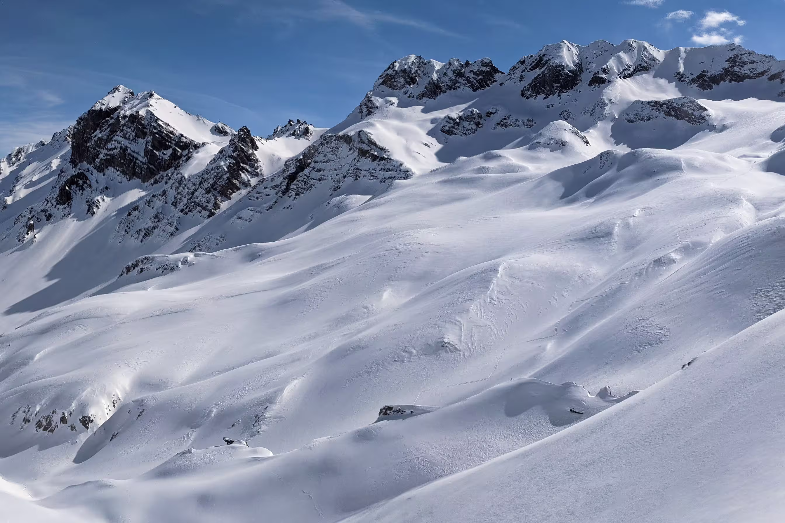 Panorama of the climber on the snow capped mountain range. Ducan Glacier in Switzerland. Freeride in the mountains