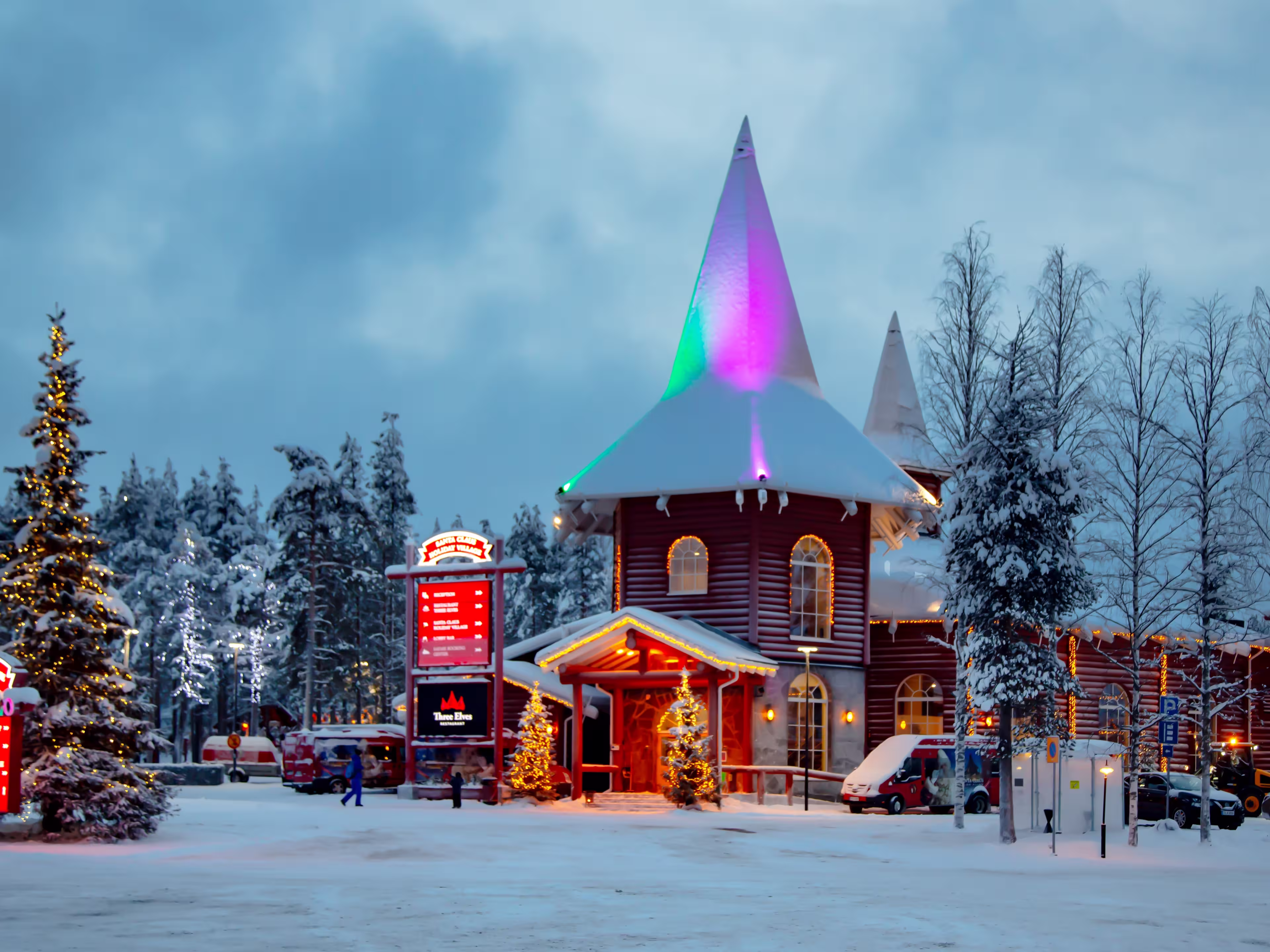 EUROPE, FINLAND, ROVANIEMI, DECEMBER 30, 2017 - Snow-covered buildings in Santa Park against the backdrop of the midnight sun. Rovaniemi, Finland.