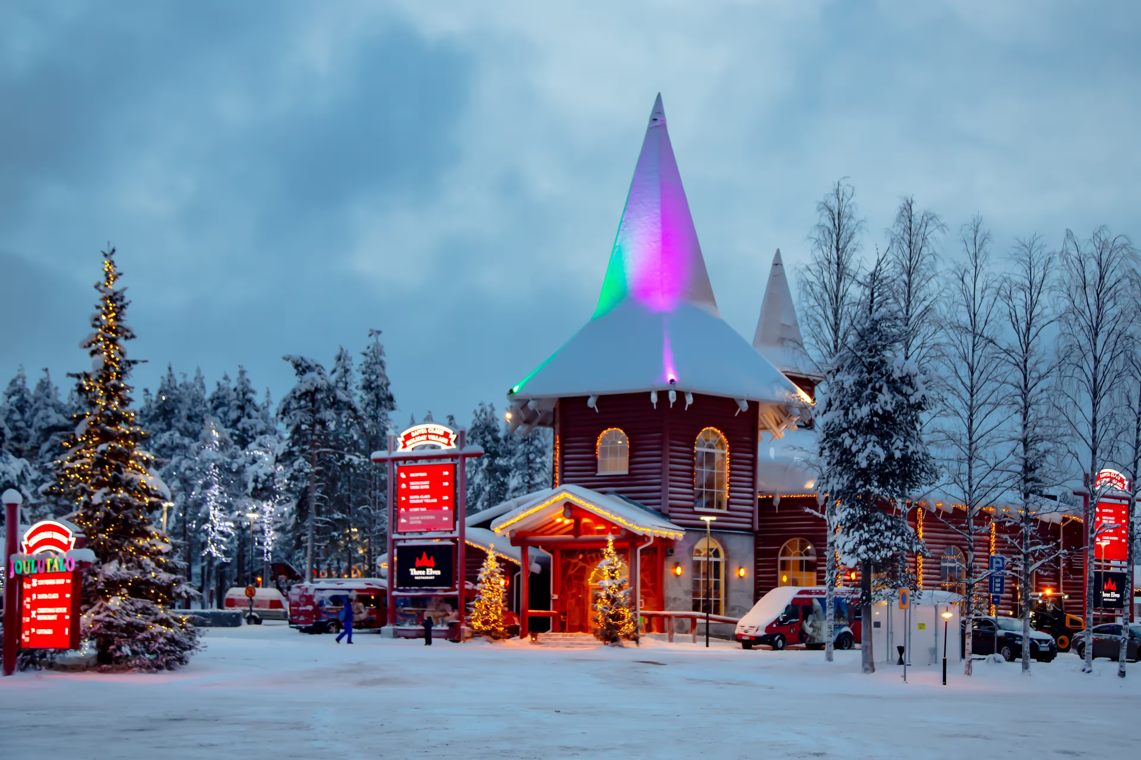 EUROPE, FINLAND, ROVANIEMI, DECEMBER 30, 2017 - Snow-covered buildings in Santa Park against the backdrop of the midnight sun. Rovaniemi, Finland.