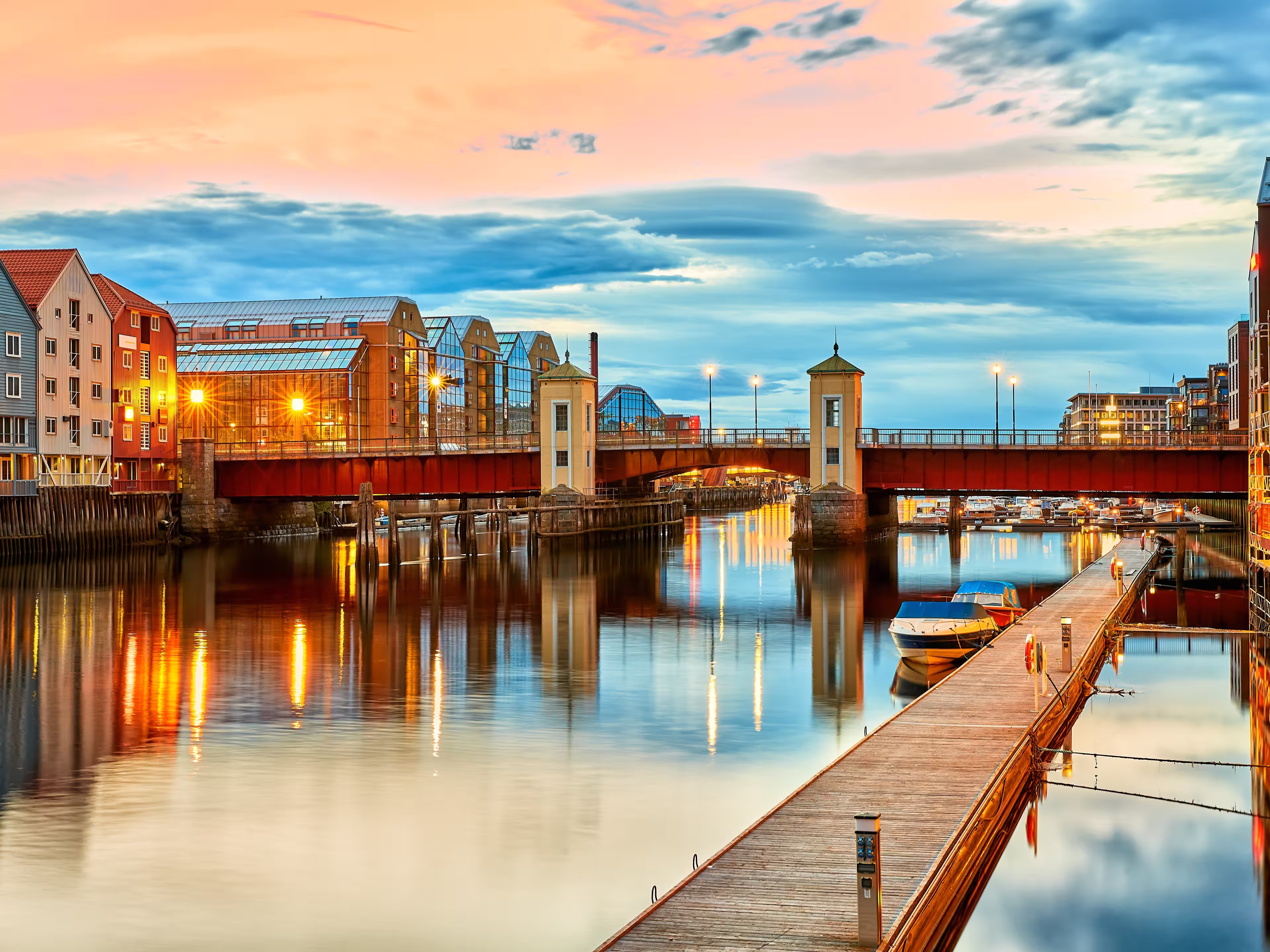 Trondheim view of the river Nidelva and the bridge Bakke Bru at summer sunset, Norway