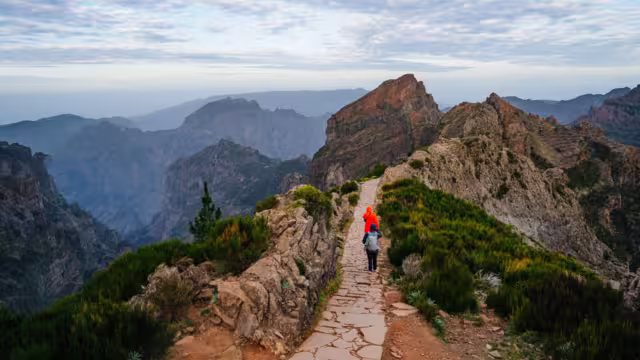 Beautiful hiking trail from Pico do Arieiro to Pico Ruivo, Madeira island. Footpath PR1 - Vereda do Areeiro. On summy summer day above the clouds. Portugal.