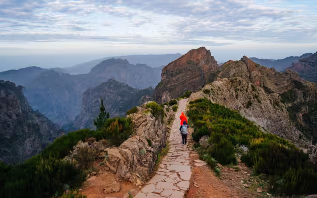 Beautiful hiking trail from Pico do Arieiro to Pico Ruivo, Madeira island. Footpath PR1 - Vereda do Areeiro. On summy summer day above the clouds. Portugal.