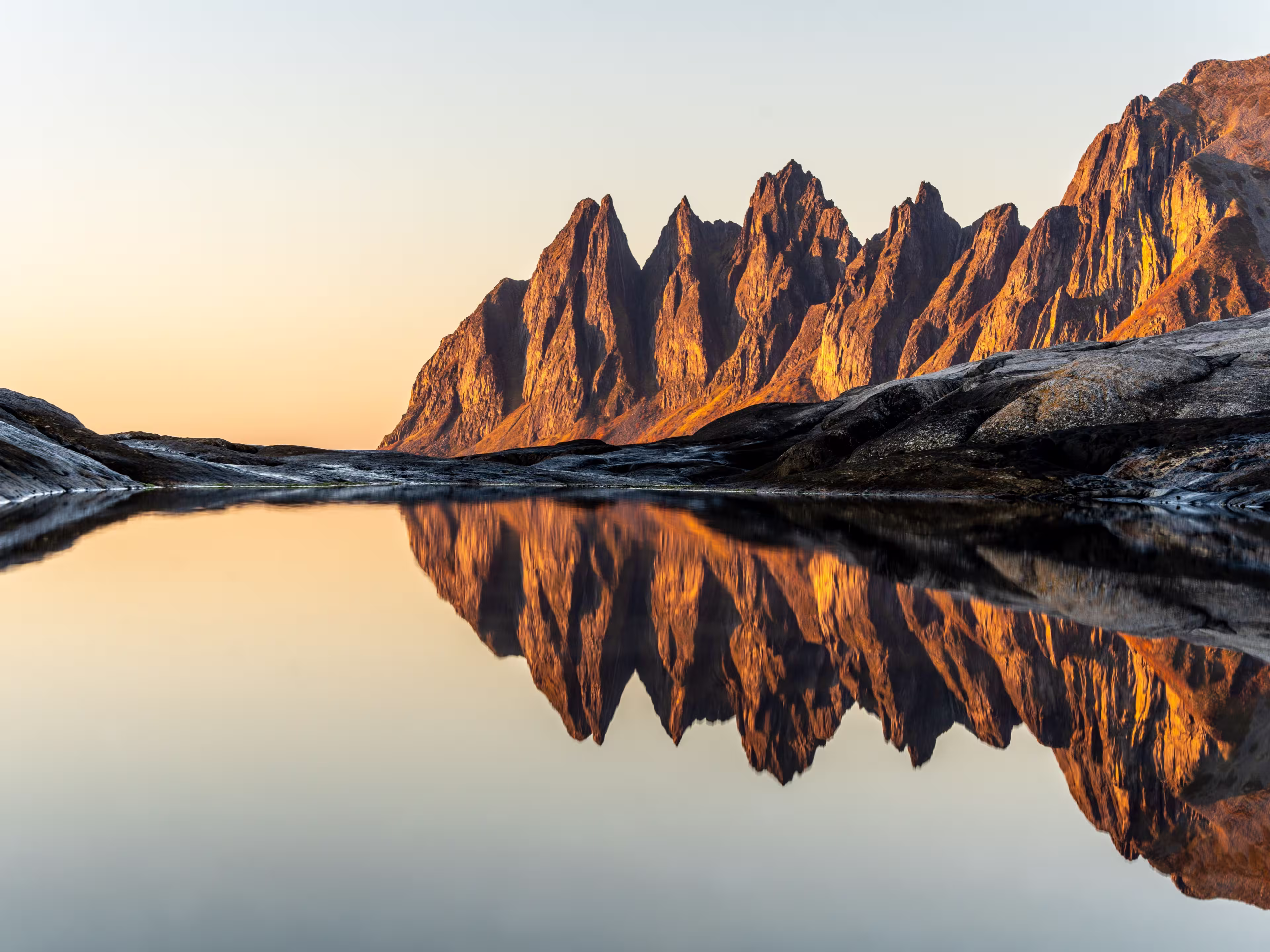 A scenic view of Devils teeth mountains in Senja, Norway, at bright sunset