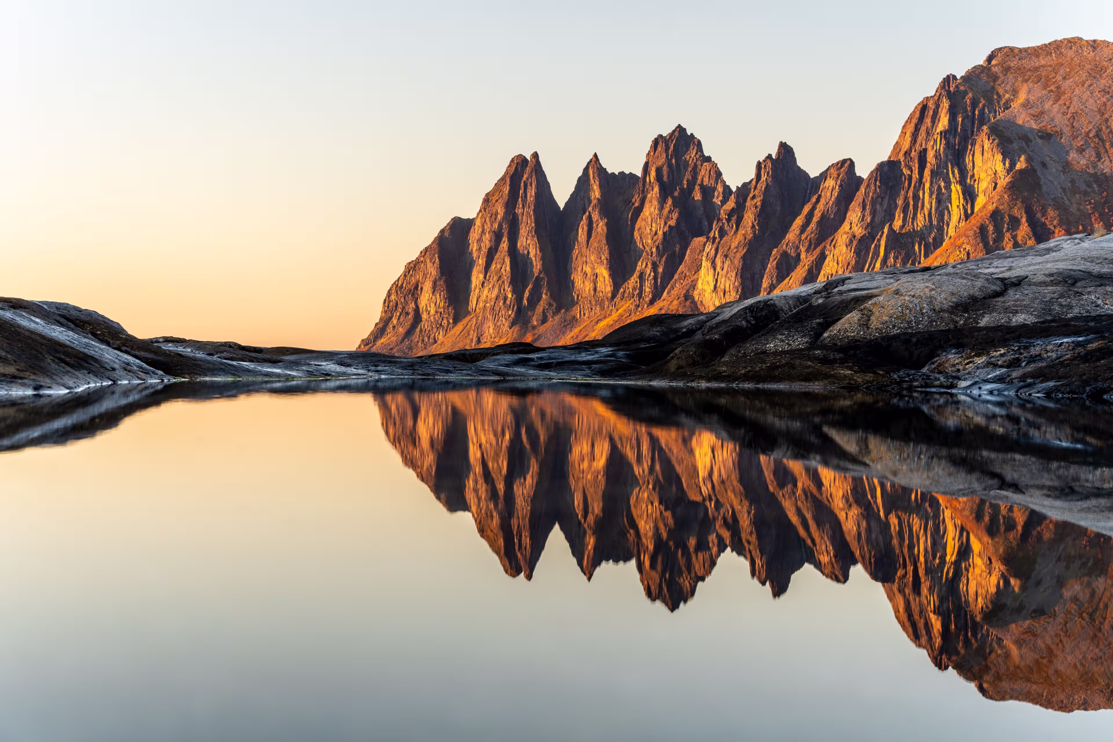 A scenic view of Devils teeth mountains in Senja, Norway, at bright sunset