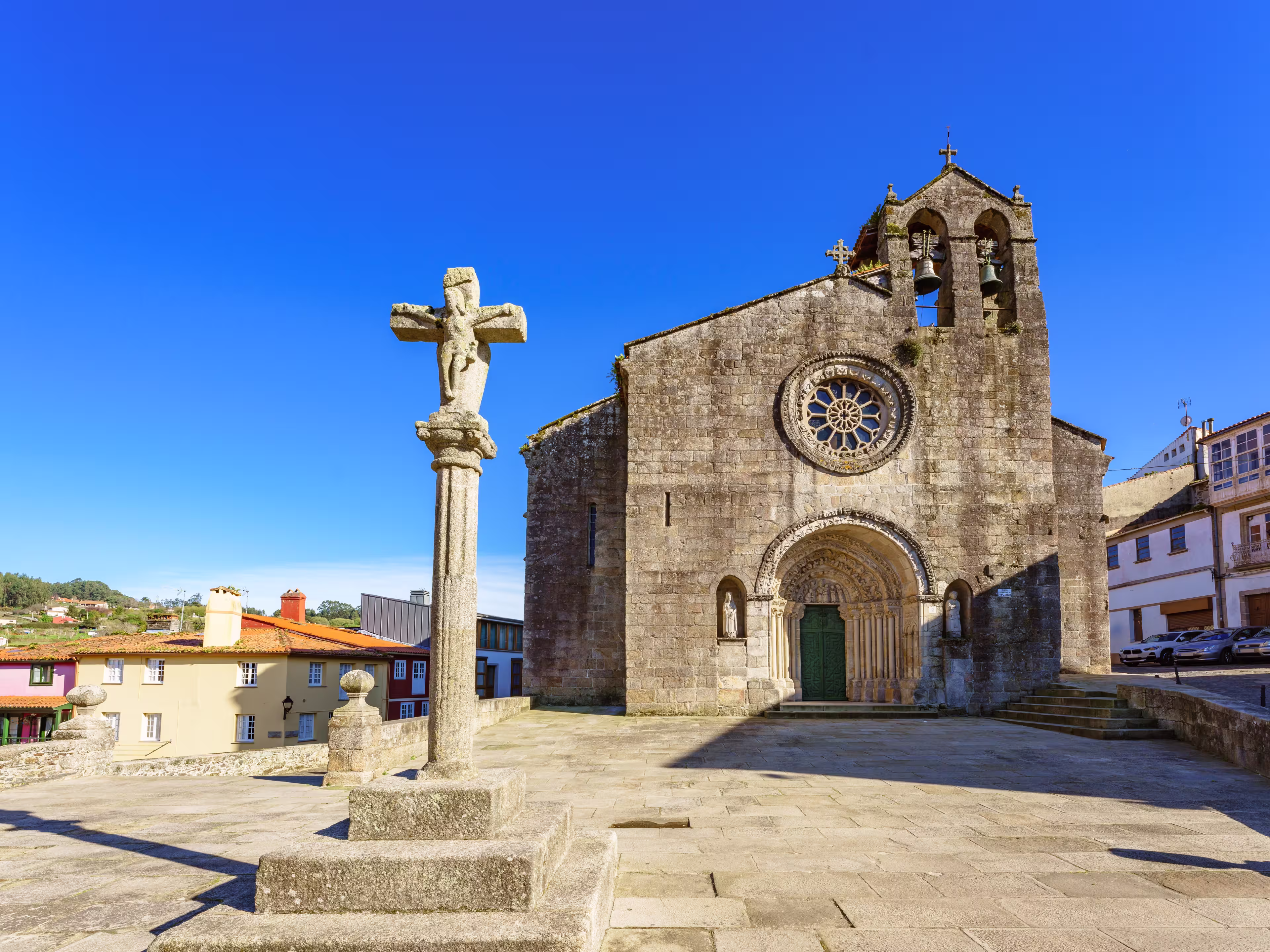 Betanzos old town Galicia Spain. View of Santa María de Azougue Parish Church and a traditional stone cross knows as Cruceiro