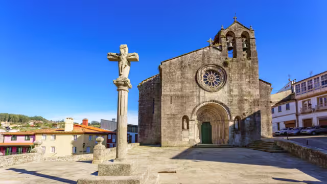 Betanzos old town Galicia Spain. View of Santa María de Azougue Parish Church and a traditional stone cross knows as Cruceiro