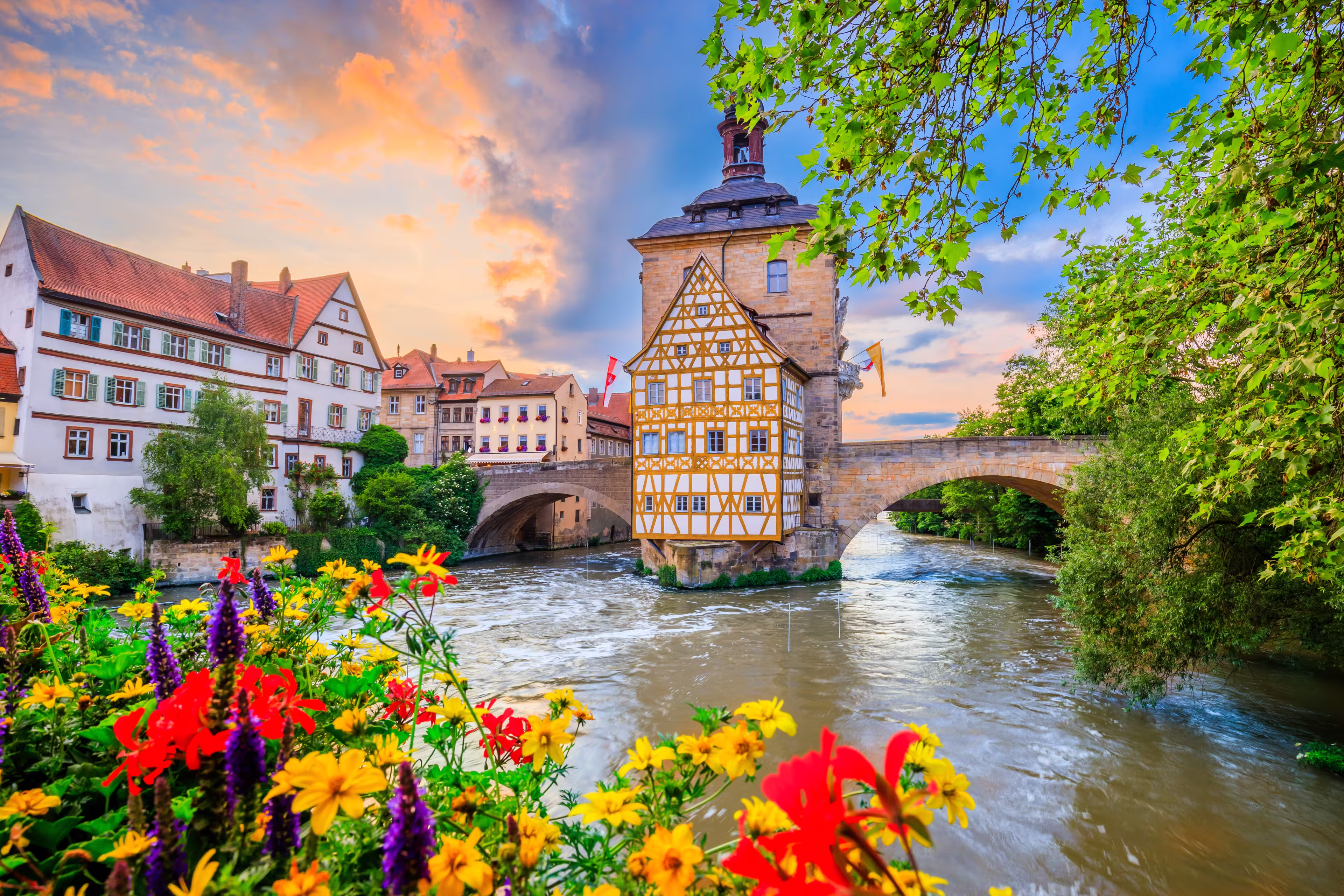 Bamberg, Germany. Town Hall of Bamberg (Altes Rathaus) with two bridges over the Regnitz river. Upper Franconia, Bavaria.