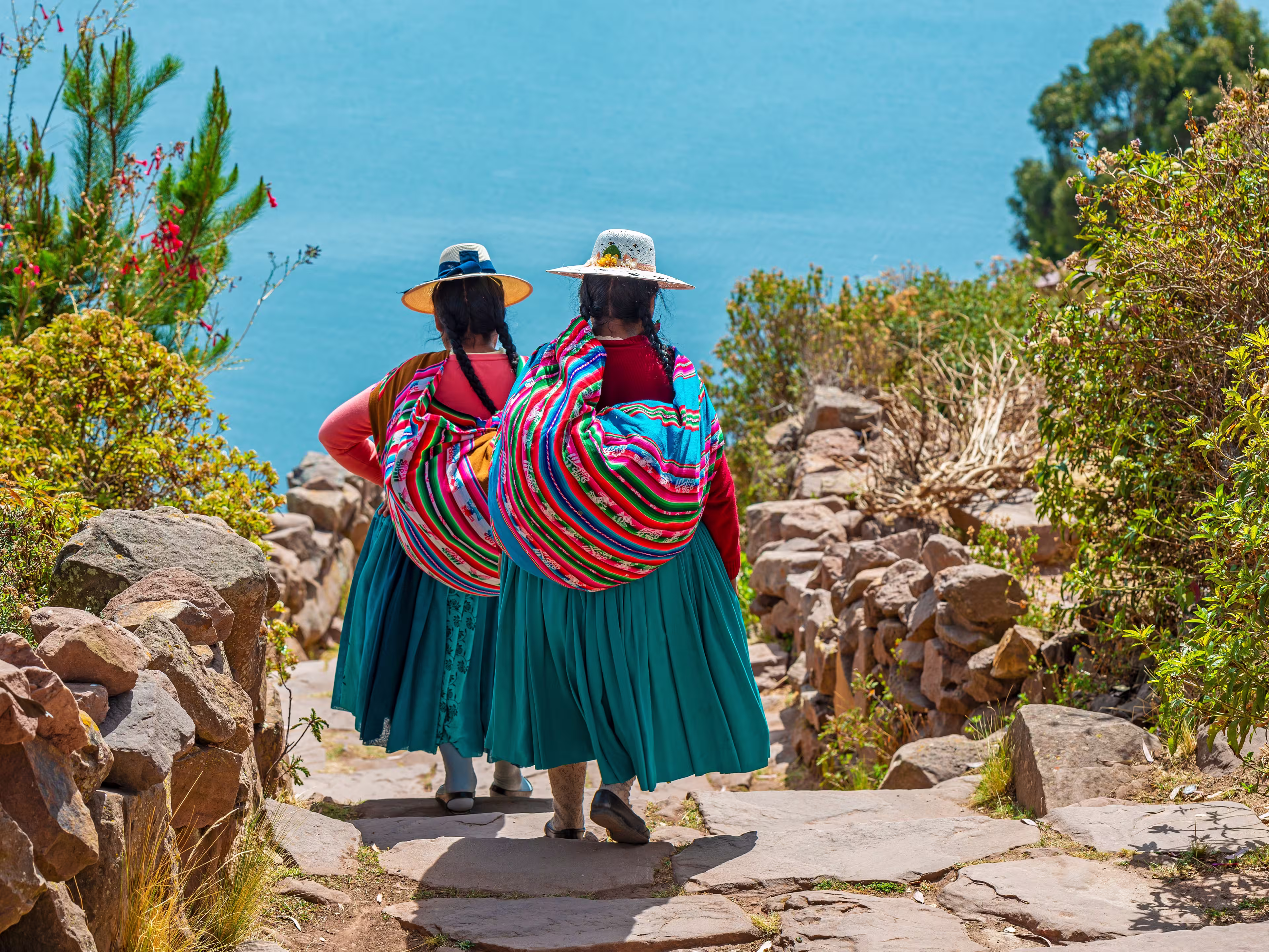 Peruvian indigenous Quechua women in traditional clothes on Taquile Island, Titicaca Lake, Peru.