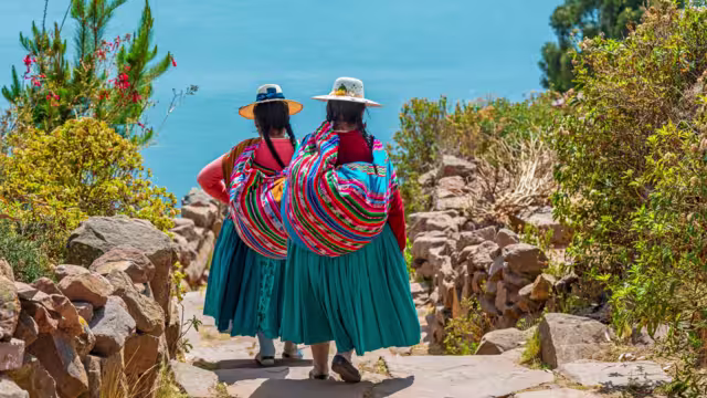 Peruvian indigenous Quechua women in traditional clothes on Taquile Island, Titicaca Lake, Peru.