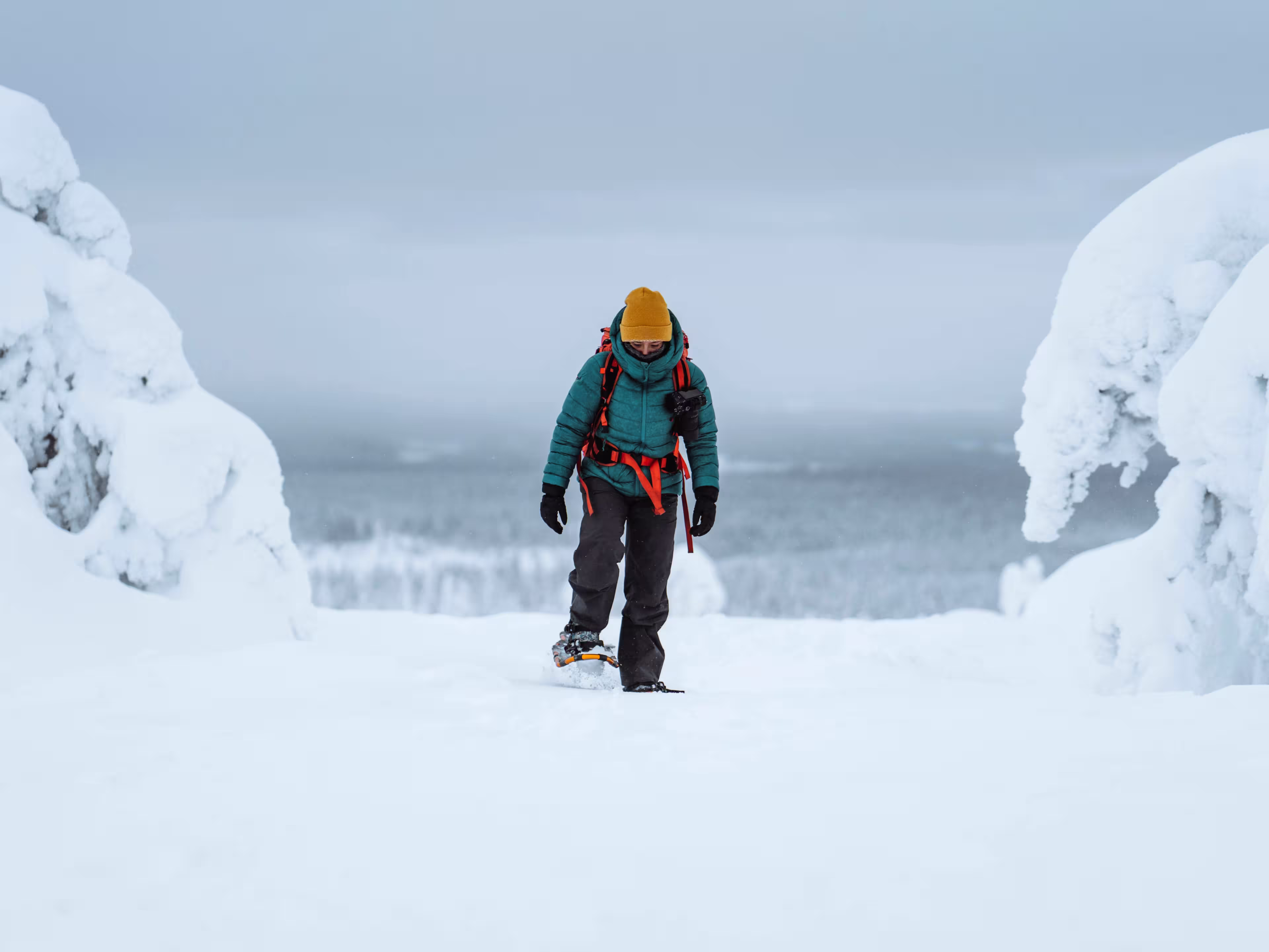 Woman trekking through a snow covered Lapland, Finland
