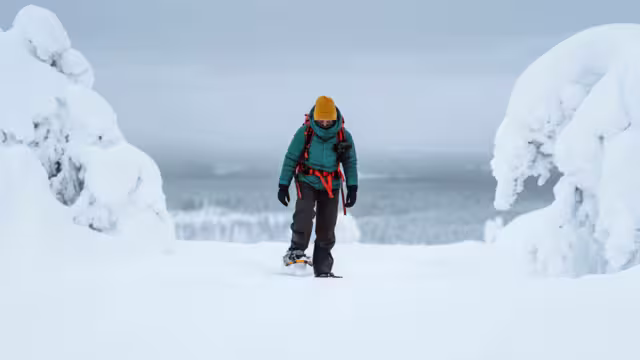Woman trekking through a snow covered Lapland, Finland
