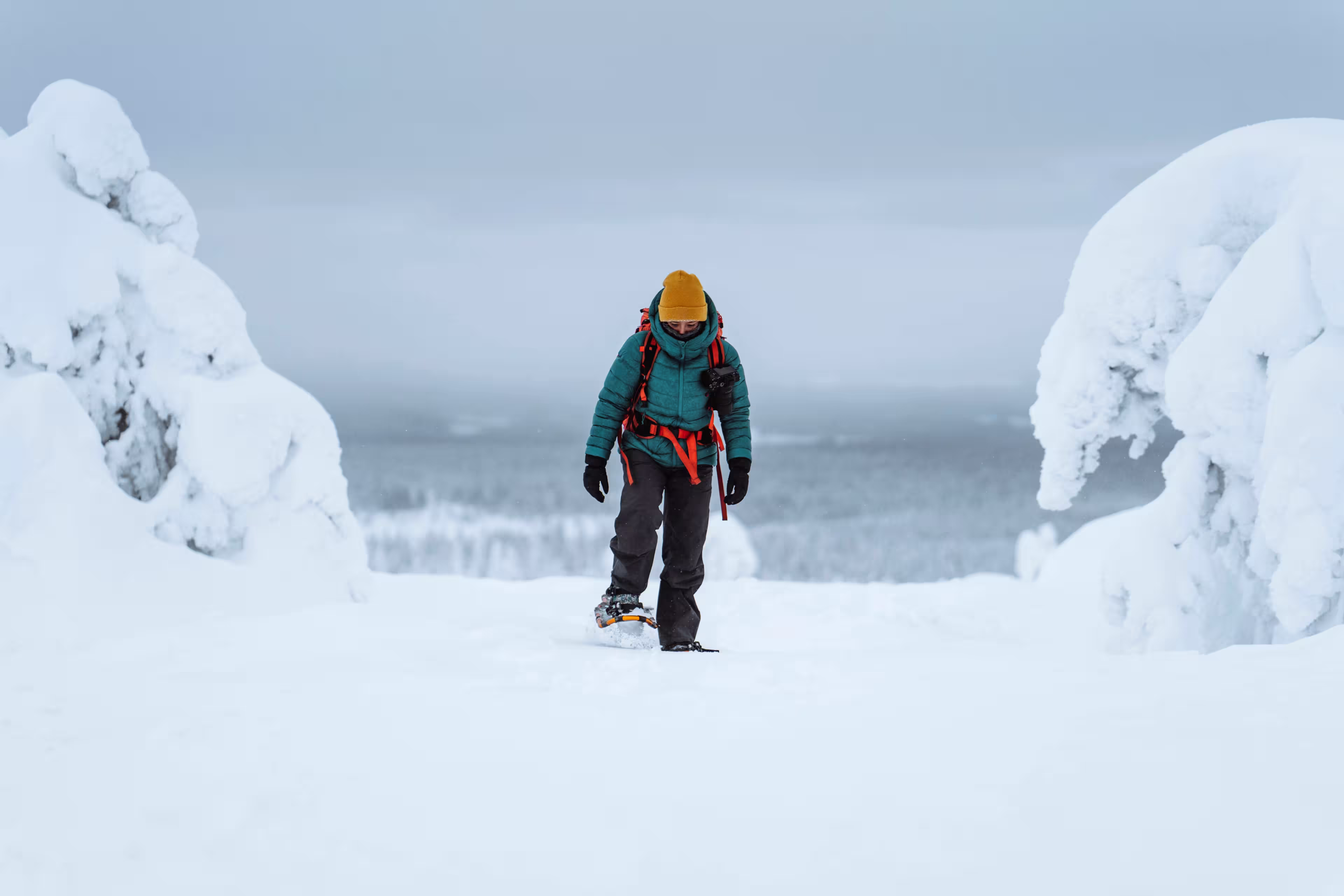 Woman trekking through a snow covered Lapland, Finland