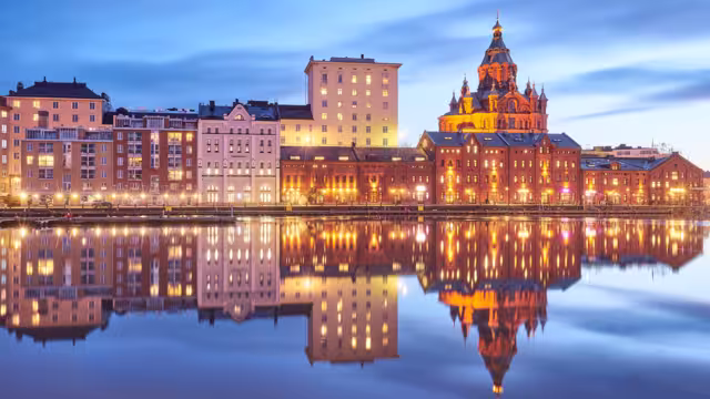 Evening view of a quay in Helsinki featuring the Uspenskin cathedral