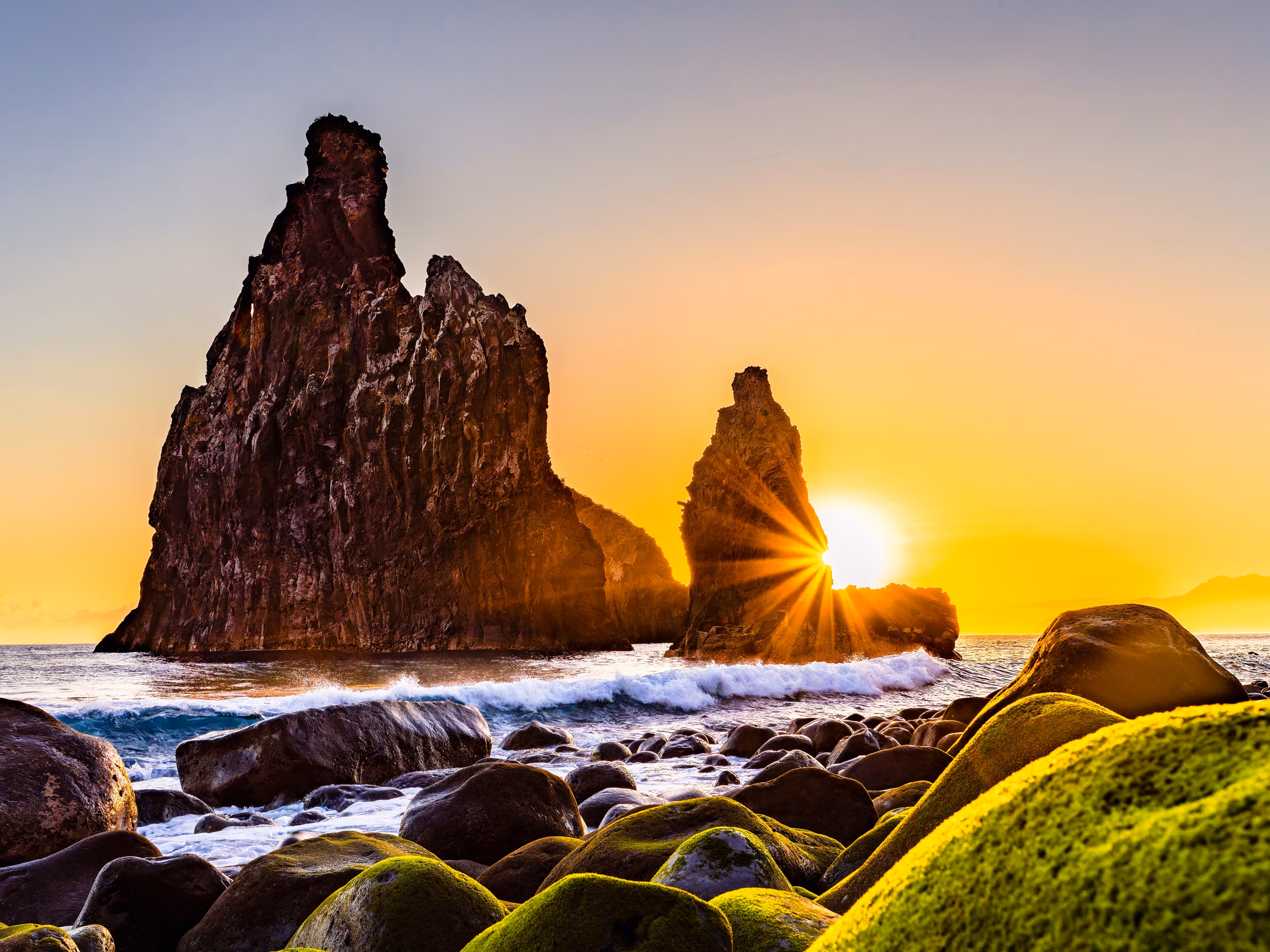lava rocks in the Atlantic Ocean, island towers in Ribeira da Janela, Madeira Island, Portugal. The rock formations are of volcanic origin in the Atlantic Ocean at sunrise