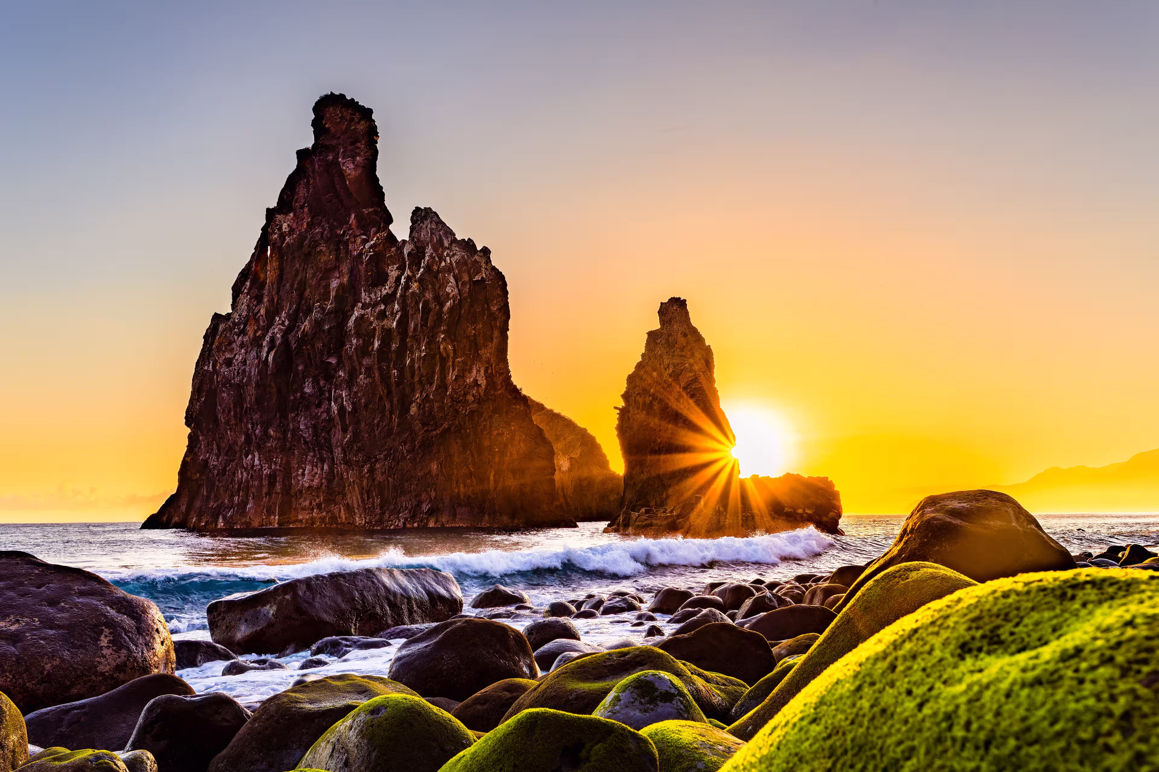 lava rocks in the Atlantic Ocean, island towers in Ribeira da Janela, Madeira Island, Portugal. The rock formations are of volcanic origin in the Atlantic Ocean at sunrise