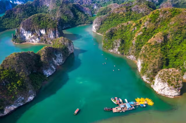 Aerial view of Sang cave and Kayaking area, Halong Bay, Vietnam, Southeast Asia. UNESCO World Heritage Site. Junk boat cruise to Ha Long Bay. Popular landmark, famous destination of Vietnam