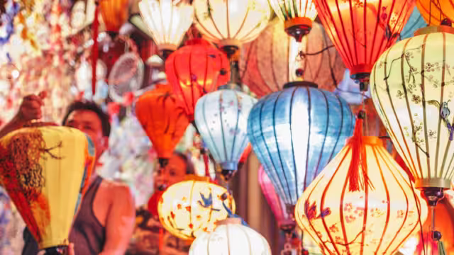 Traveller looks at lanterns at local market in Hoi An, Vietnam