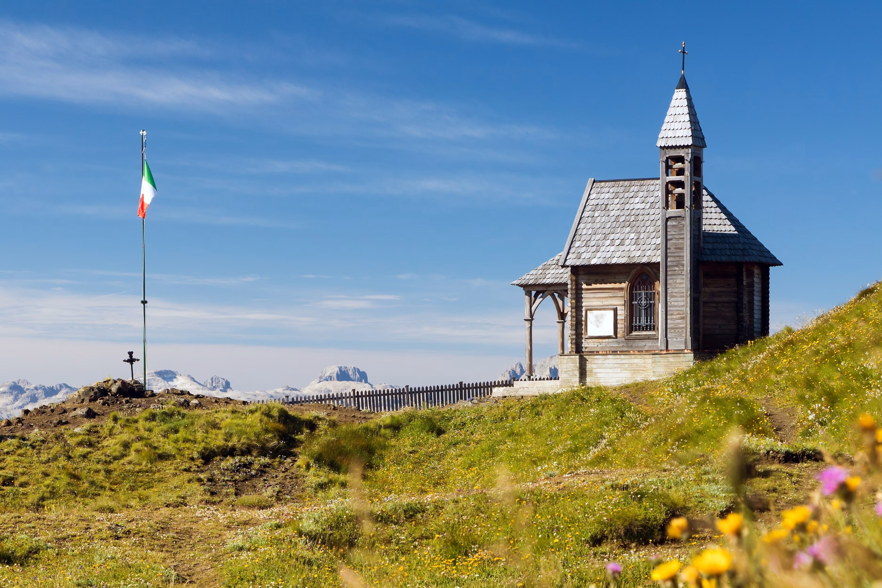 Small wooden church or chapel on the mountain top Col di Lana, Alps Dolomites mountains, Italy
