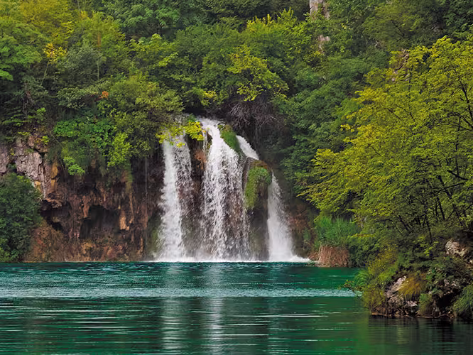 Beautiful waterfall surrounded by forest in Plitvice National Park, Croatia