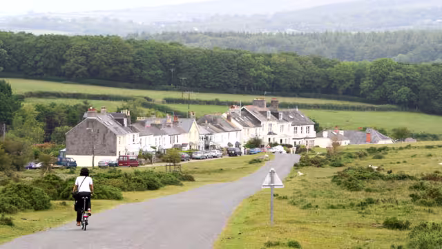 Woman in holidays cycling around Cornwall and Devon
