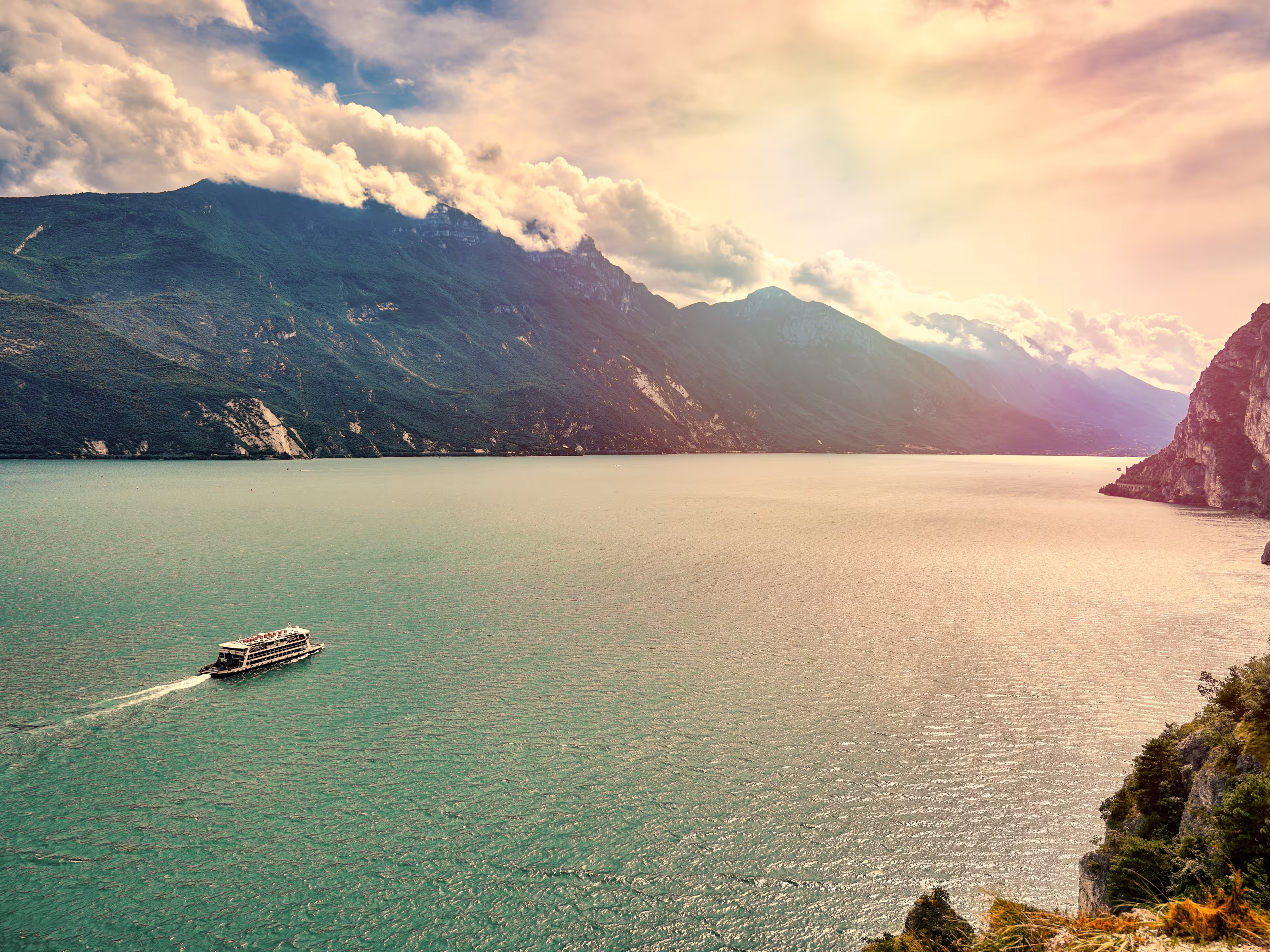 View of the beautiful Lake Garda surrounded by mountains, Riva del Garda town and Garda lake in the autumn time , Trentino Alto Adige region,Italy