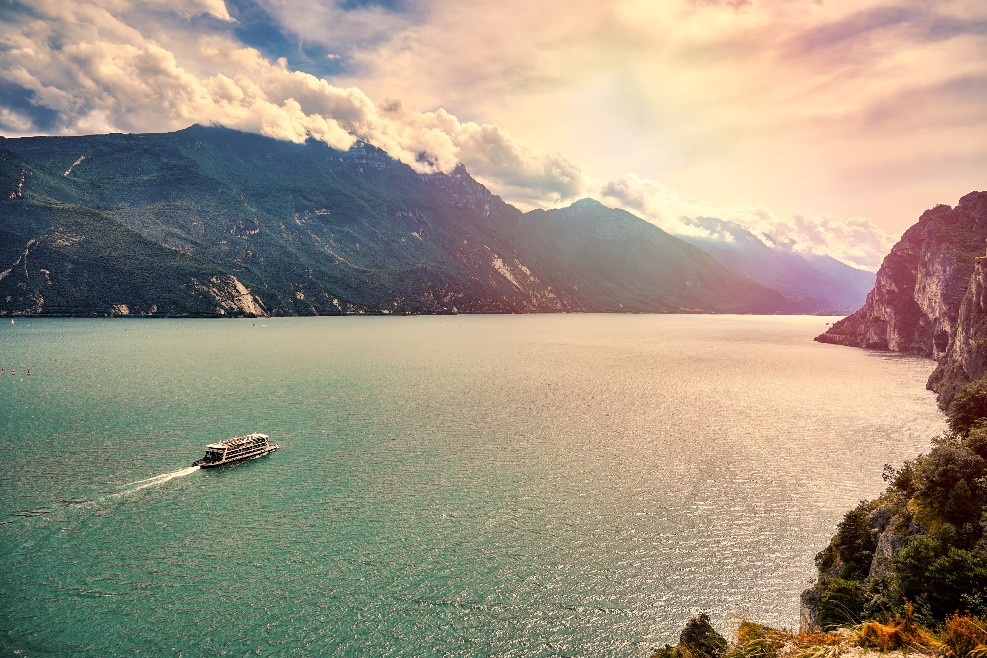 View of the beautiful Lake Garda surrounded by mountains, Riva del Garda town and Garda lake in the autumn time , Trentino Alto Adige region,Italy