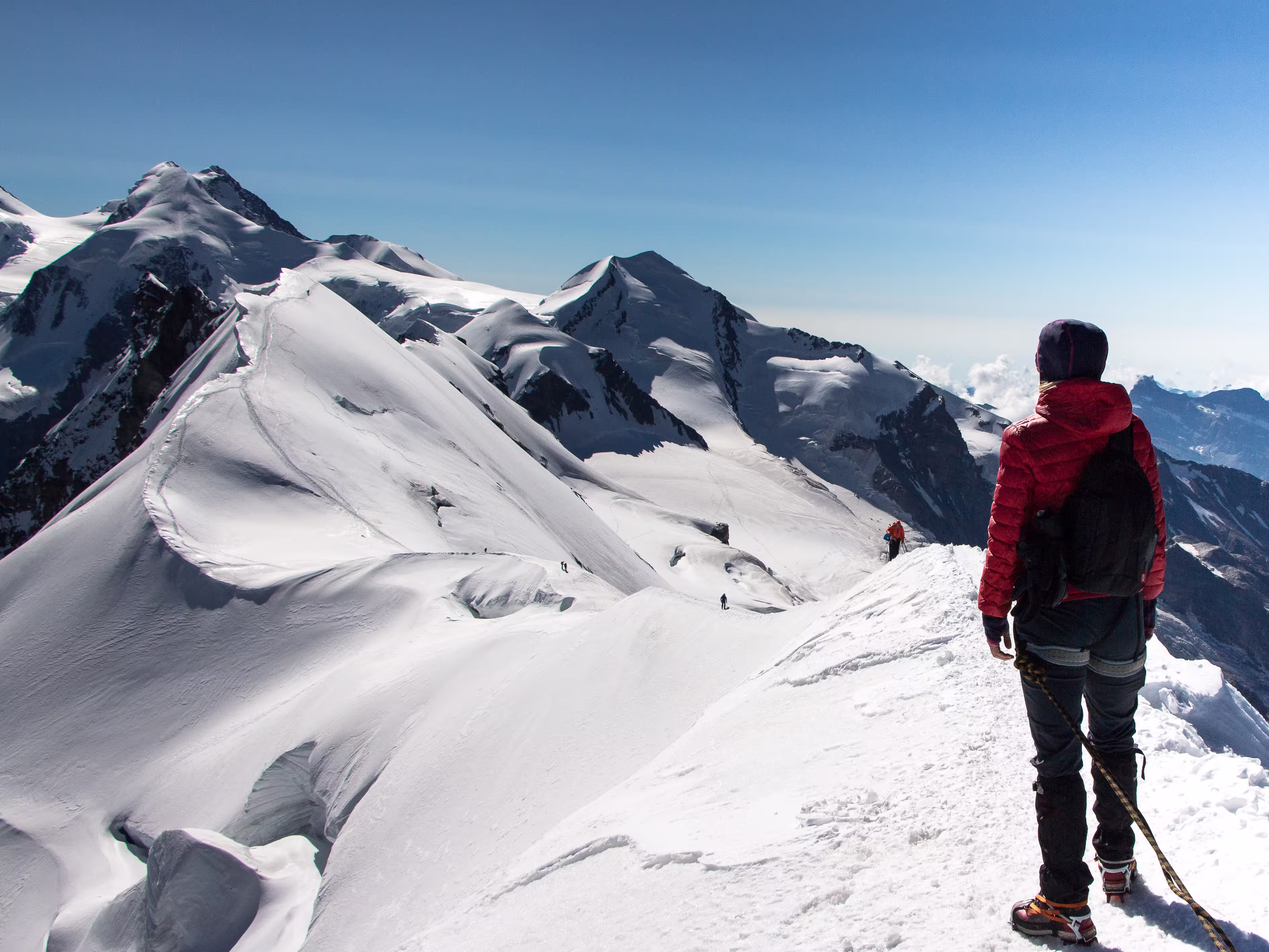 Hiker woman on top of Breithorn mountain, 4164 m above sea level. Zermatt, Pennine Alps, Switzerland, Europe.