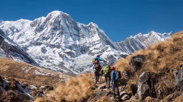 Trekking in Annapurna region, with Annapurna South in background, Nepal