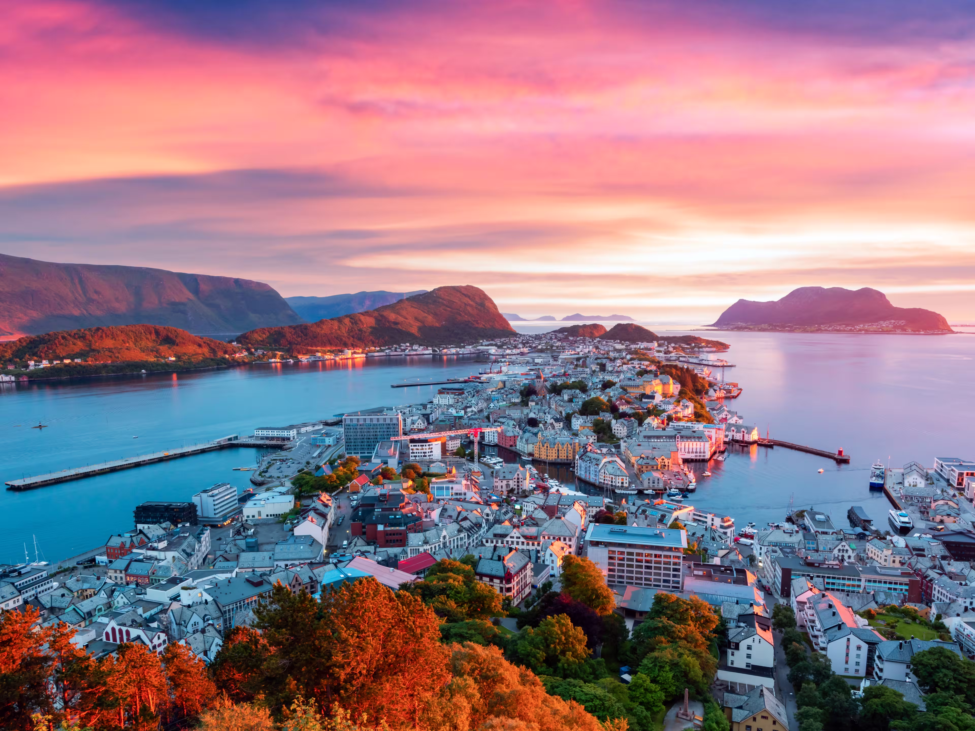 Colorful sunset in Alesund port town on western coast of Norway. Place where the ocean meet the mountains. Landscape photography