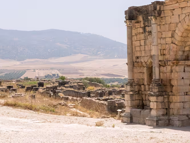 XMPSC - Group of travellers walking through Volubilis ruins, Morocco