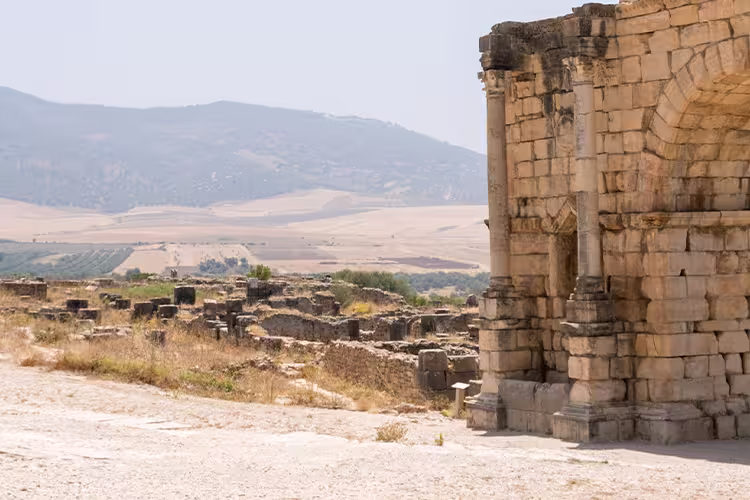 XMPSC - Group of travellers walking through Volubilis ruins, Morocco