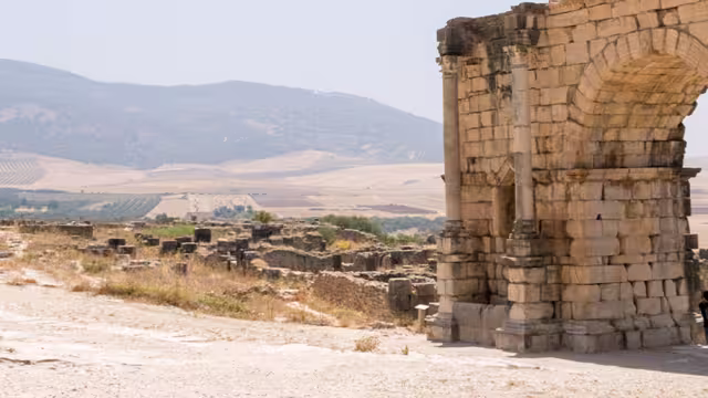 XMPSC - Group of travellers walking through Volubilis ruins, Morocco