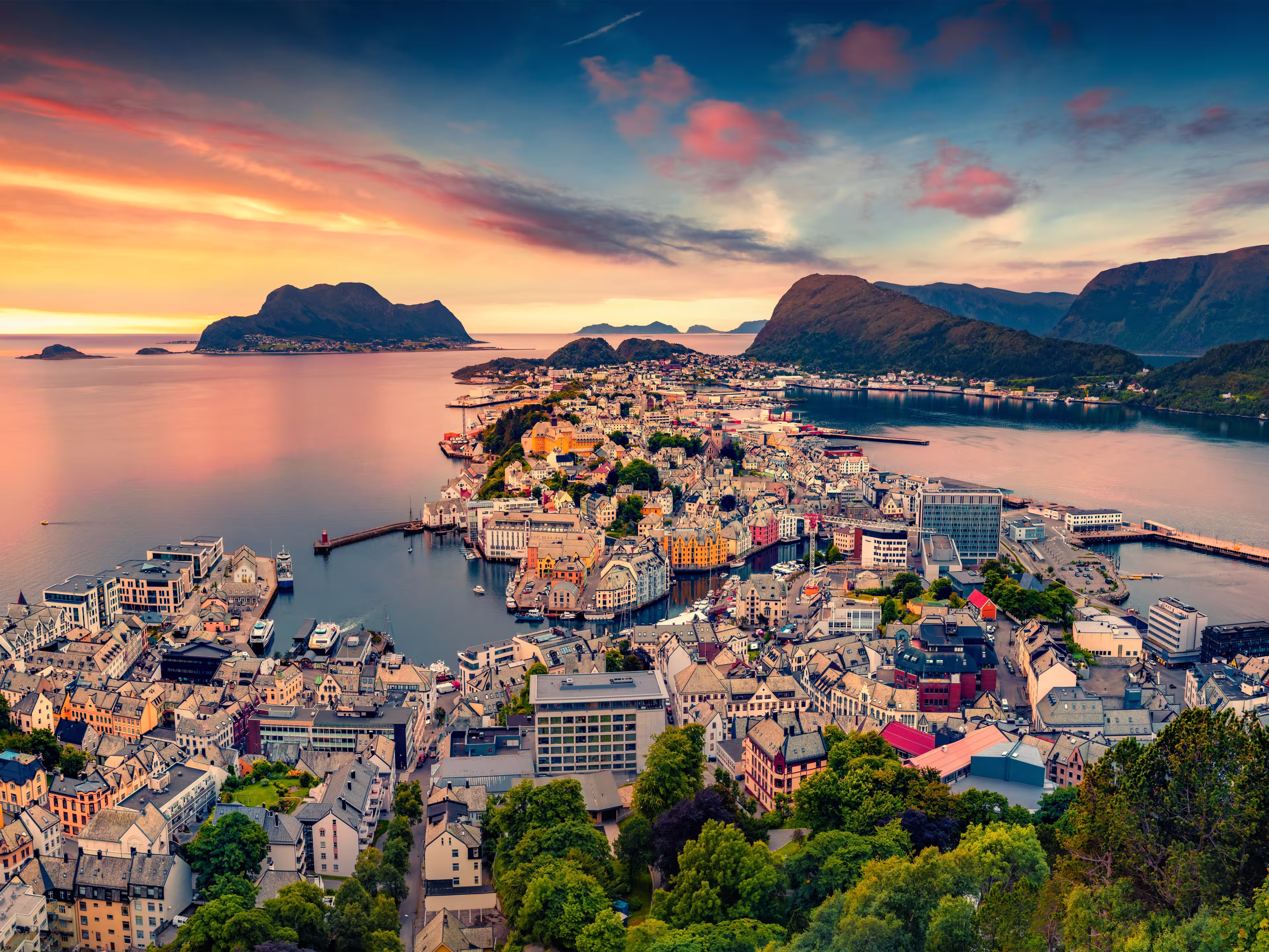 Picturesque summer view from flying drone of Alesund port. Great sunset in west coast of Norway, at the entrance to the Geirangerfjord. Traveling concept background.