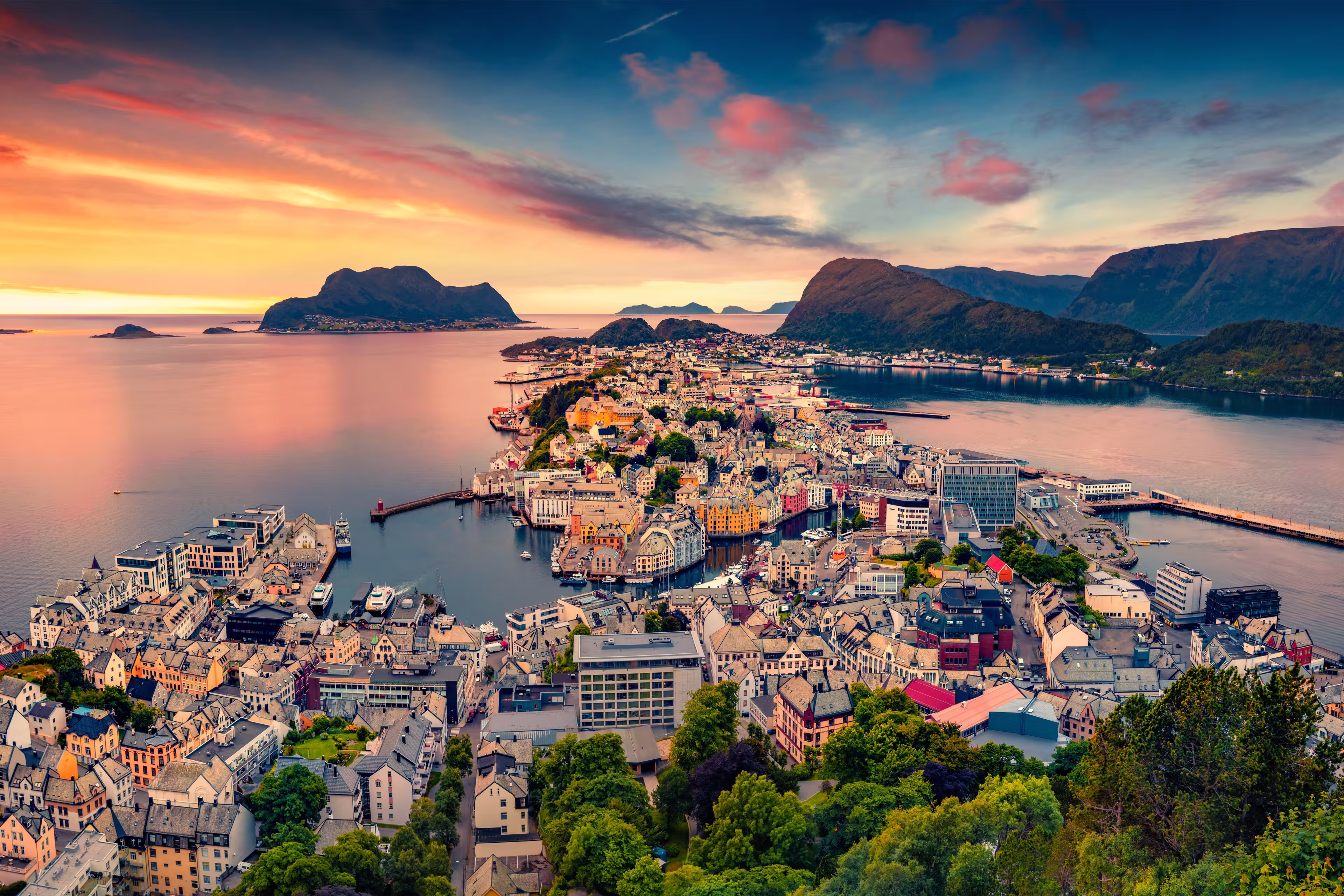 Picturesque summer view from flying drone of Alesund port. Great sunset in west coast of Norway, at the entrance to the Geirangerfjord. Traveling concept background.