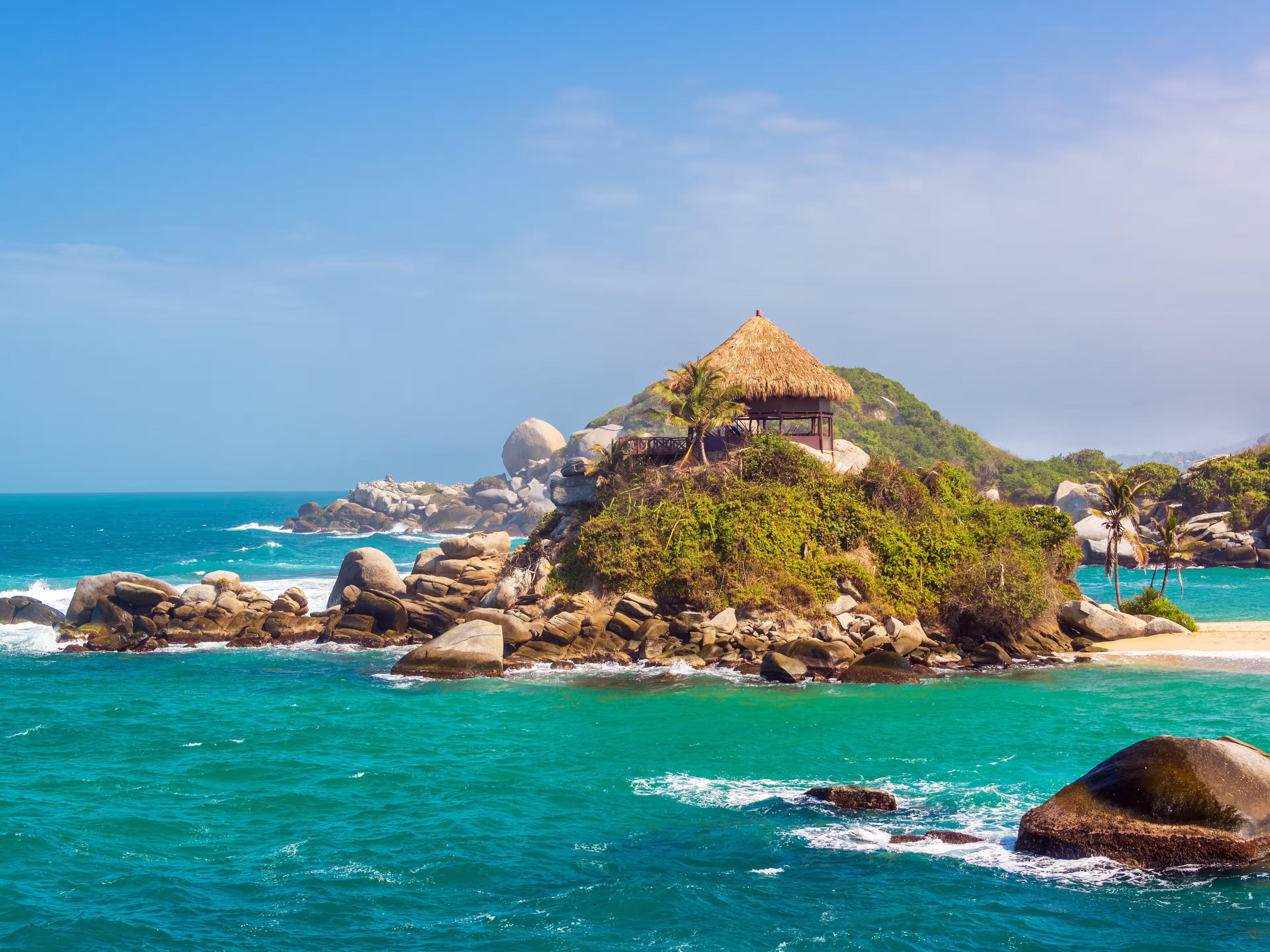 Turquoise water and beach shack at Cabo San Juan del Guia in Tayrona National Park in Colombia