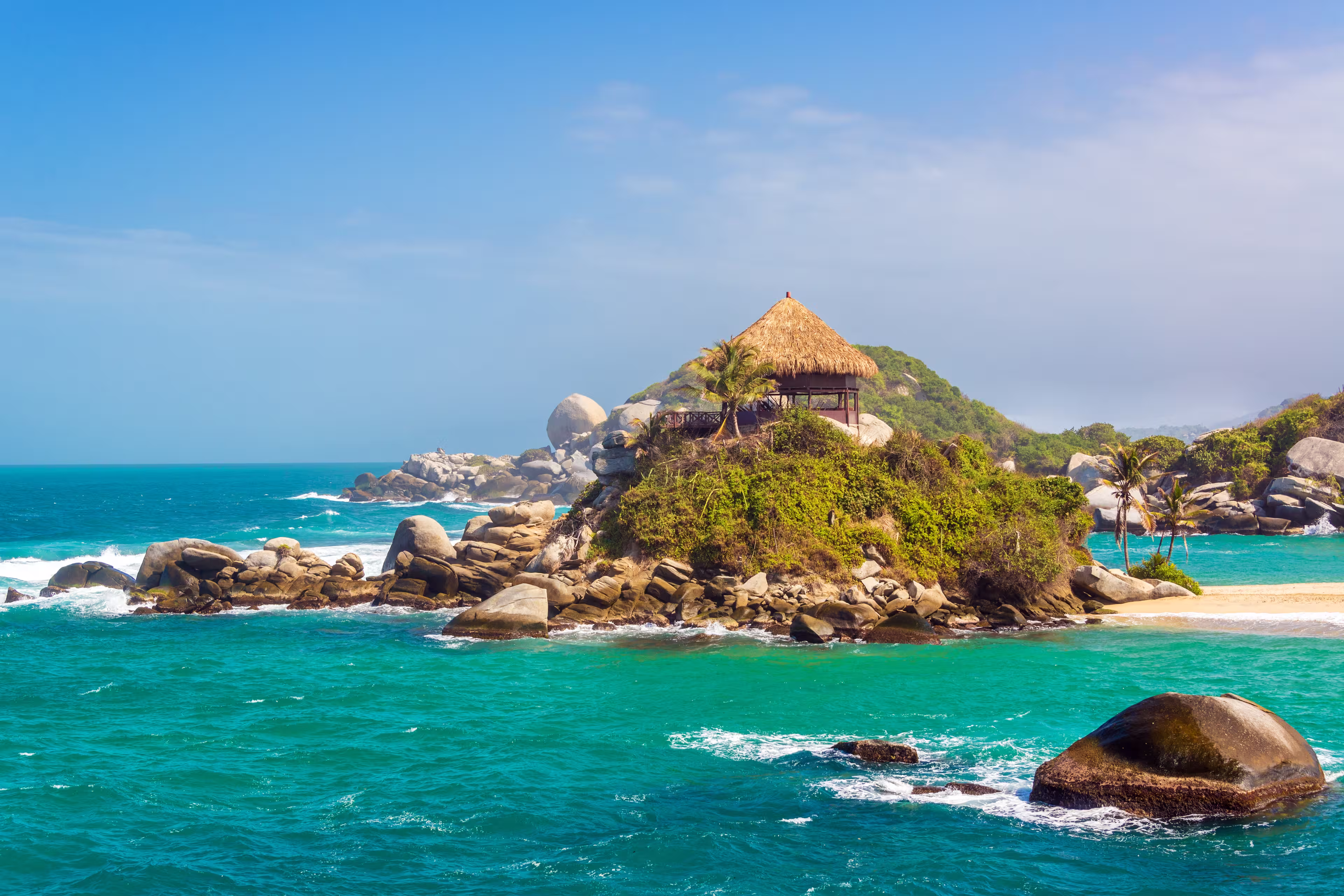 Turquoise water and beach shack at Cabo San Juan del Guia in Tayrona National Park in Colombia