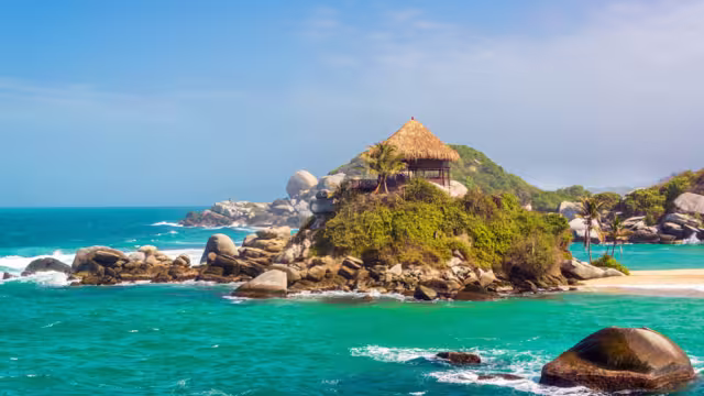 Turquoise water and beach shack at Cabo San Juan del Guia in Tayrona National Park in Colombia