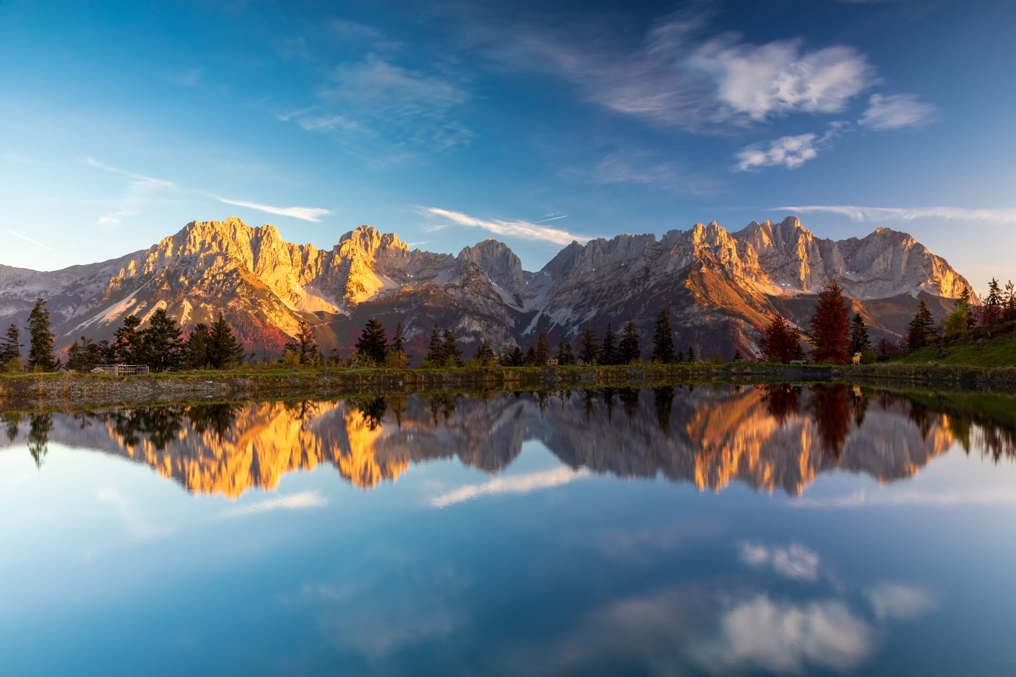 Alpenglow at Wilder Kaiser mountains reflected in lake Astbergsee, Going, Tyrol, Austria