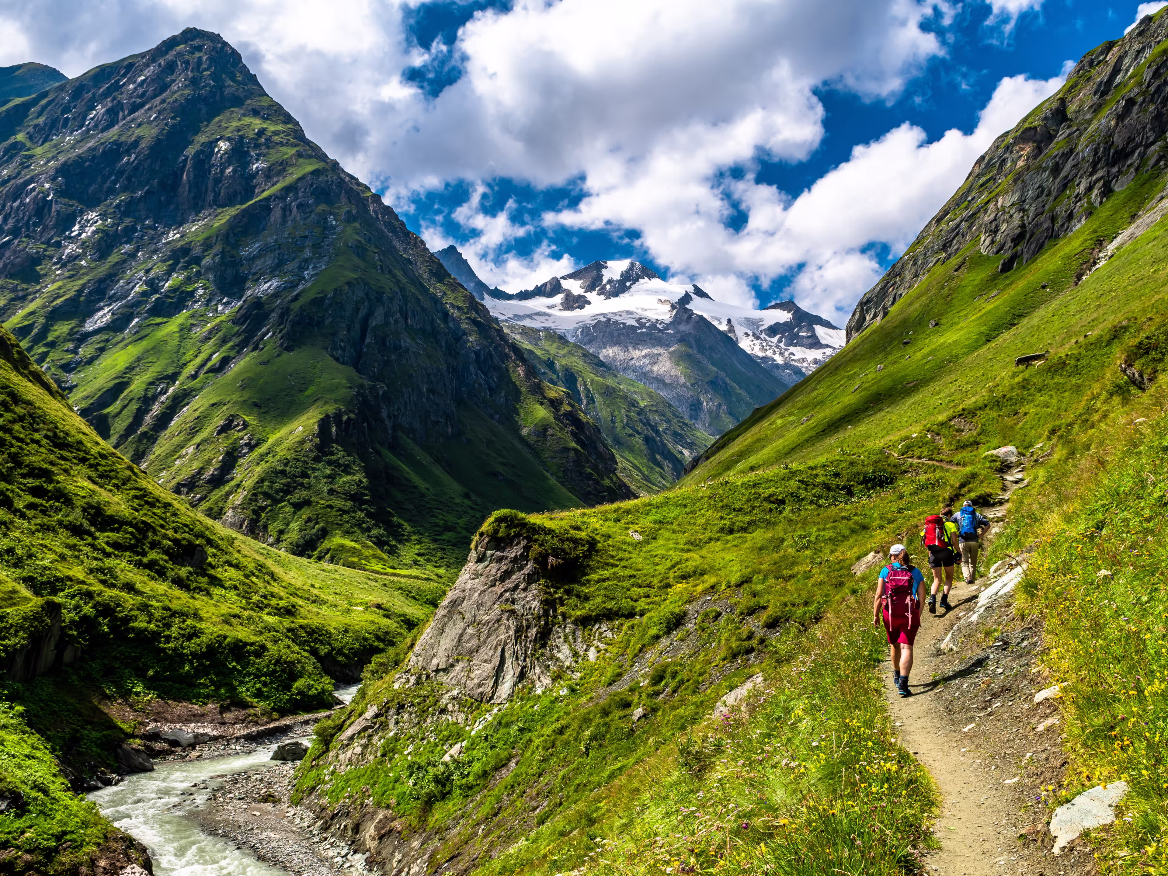 Hiking Group In Valley Of Umbalfaelle On Grossvenediger With View To Mountain Roetspitze In Nationalpark Hohe Tauern In Tirol In Austria