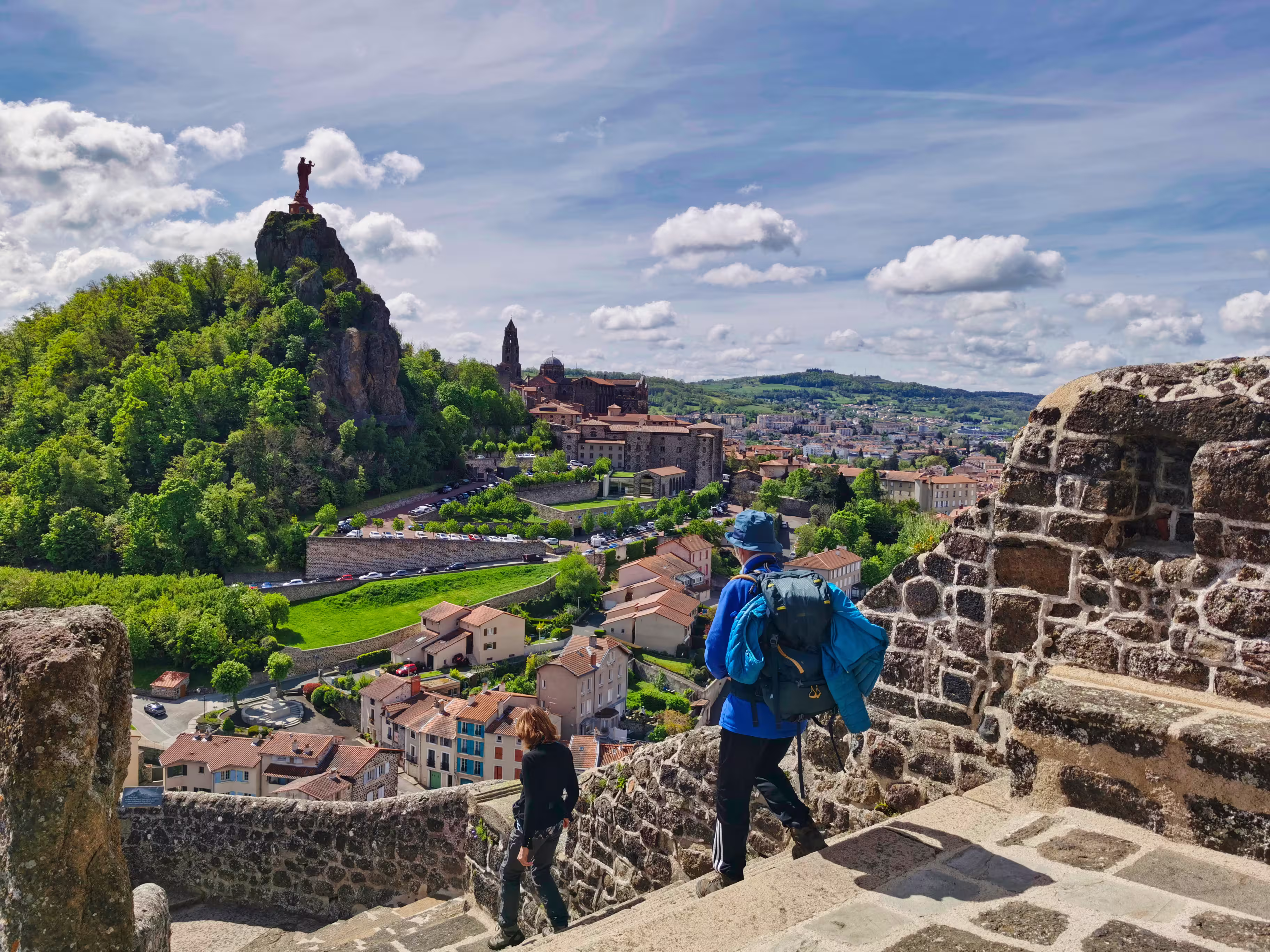 Pilgrims descending from the rock of saint michel, in Puy en Velay. Departure of the way of saint james