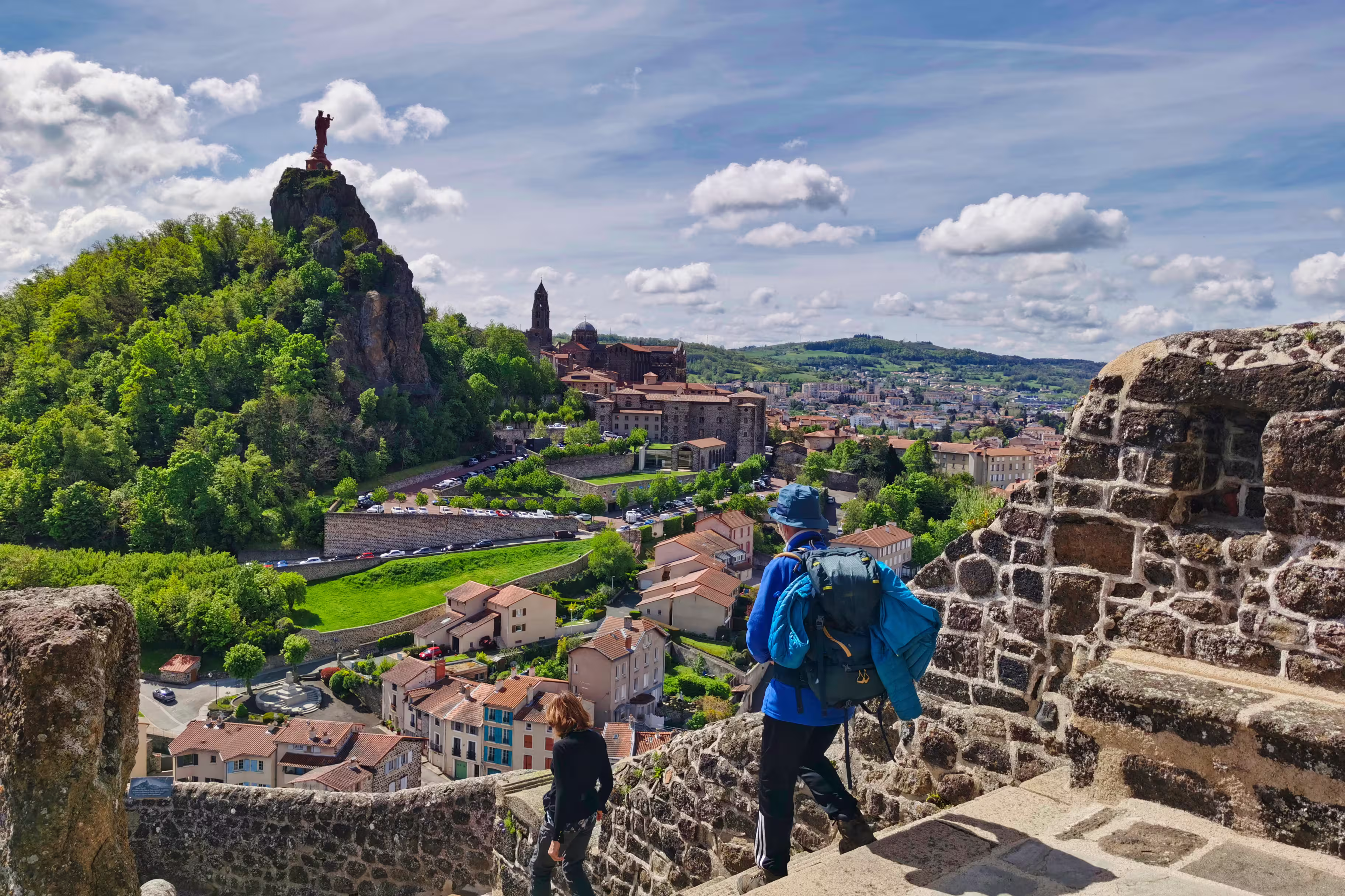 Pilgrims descending from the rock of saint michel, in Puy en Velay. Departure of the way of saint james
