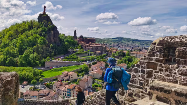 Pilgrims descending from the rock of saint michel, in Puy en Velay. Departure of the way of saint james