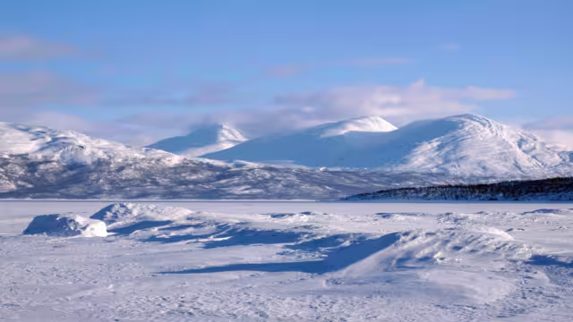 Beautiful scenery of frozen and snowy Lake Torneträsk (Tornestrask) around Abisko National Park (Abisko nationalpark). Sweden, Arctic Circle, Swedish Lapland