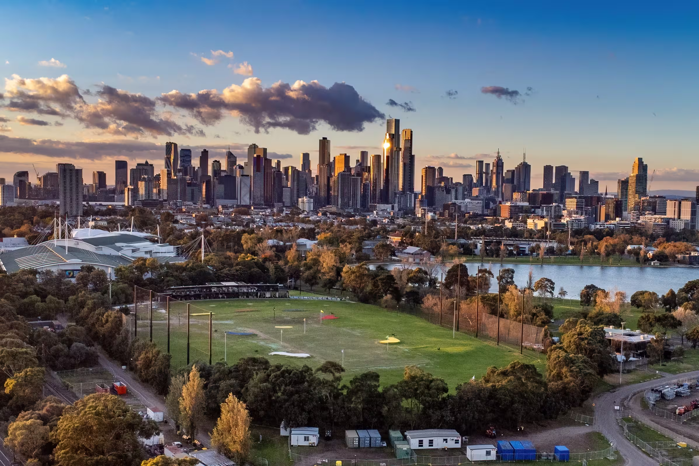 Melbourne, Victoria, Australia - Aerial view of Albert Park lake, golf driving range and Melbourne city skyline at sunset.
